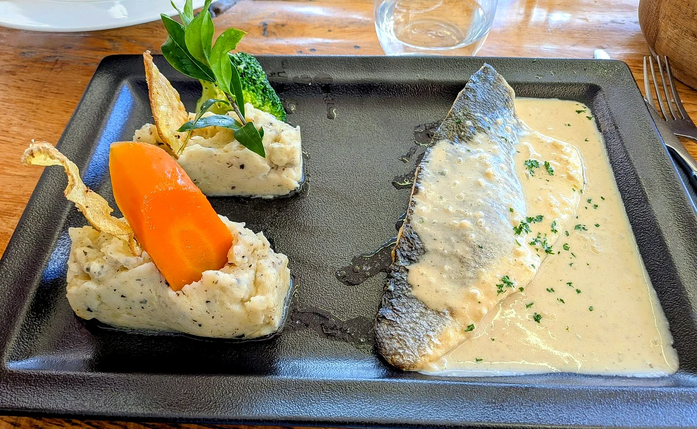 Poisson nappé d'une sauce crémée, légumes du marché